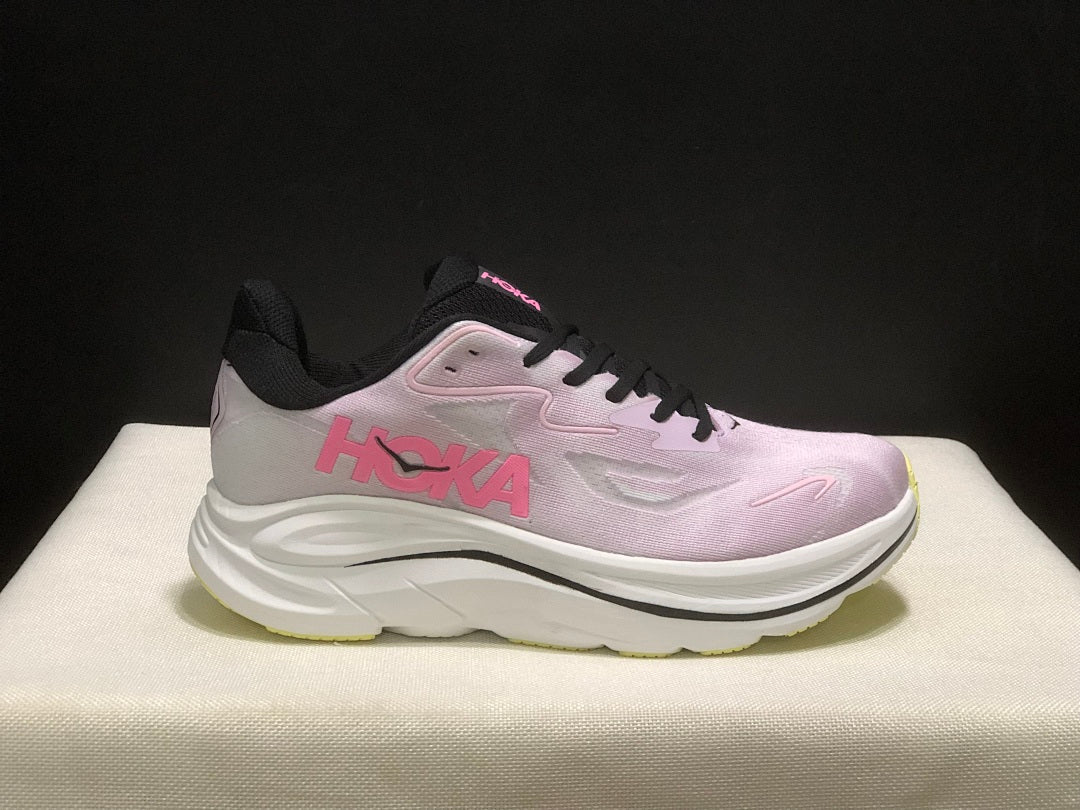 Pink and White HOKA Clifton 10 Running Shoes - product image from the listing.