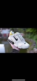 Nike White and Black Trainers with Yellow Accents - product image from the listing.
