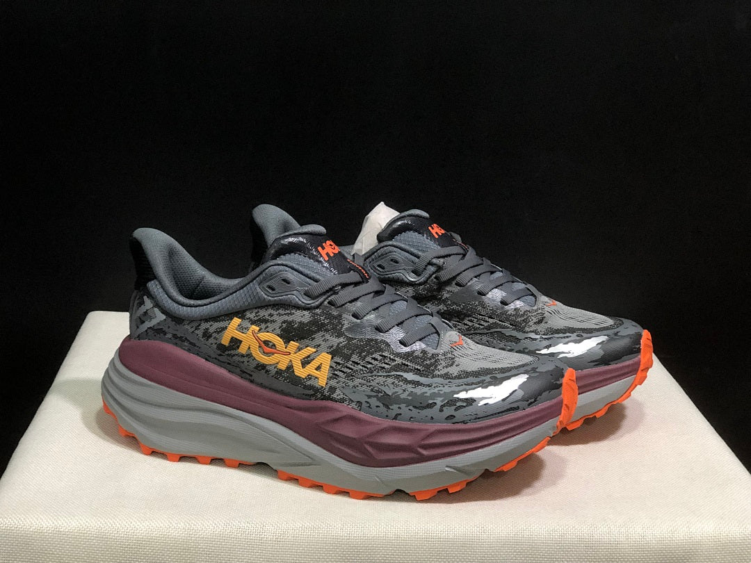 HOKA Stinson 7 Trail Running Shoes in Gray Orange - product image from the listing.
