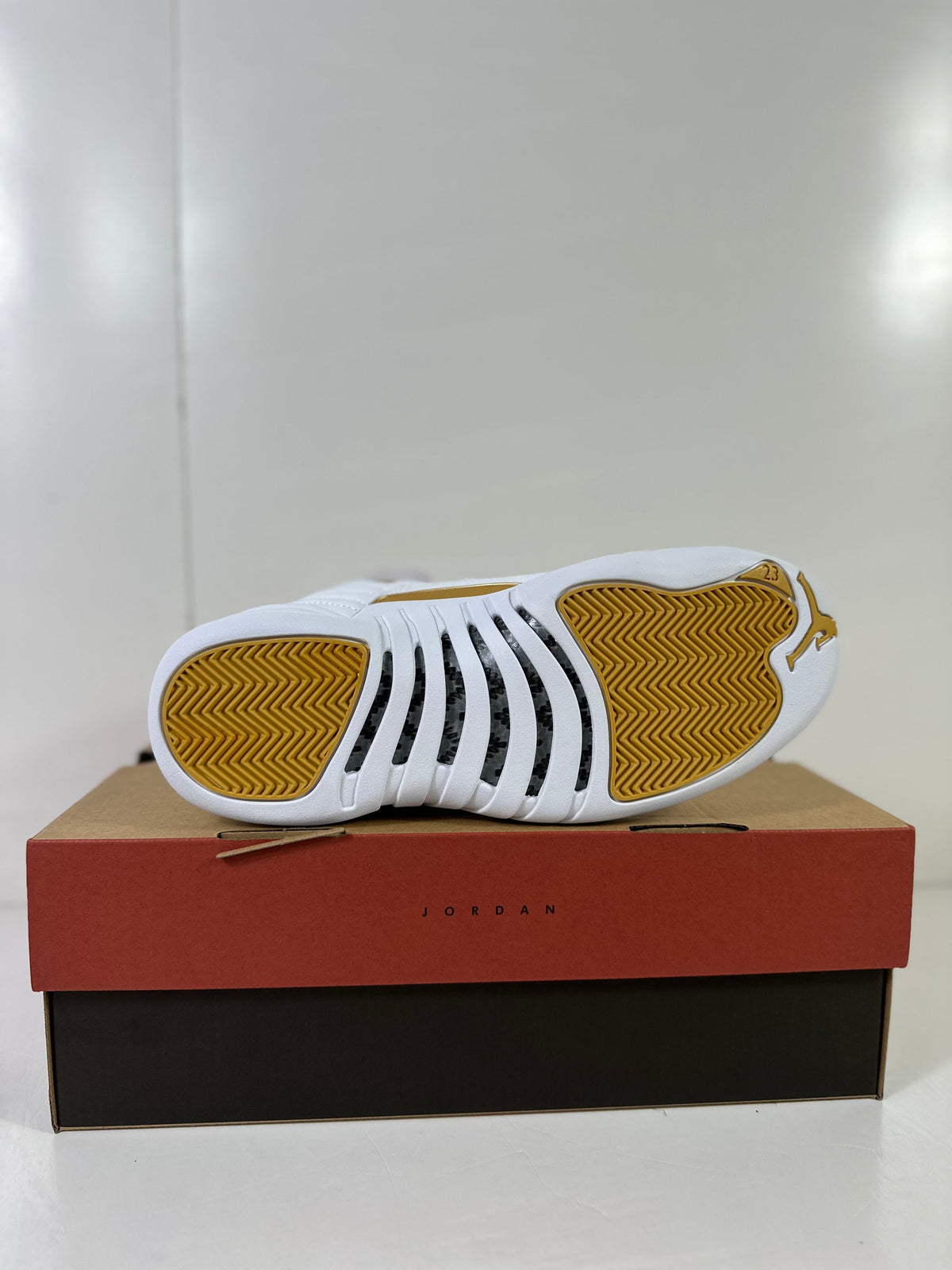 Air Jordan 12 Phantom White Metallic Gold Sneakers FD9101-007 - product image from the listing.
