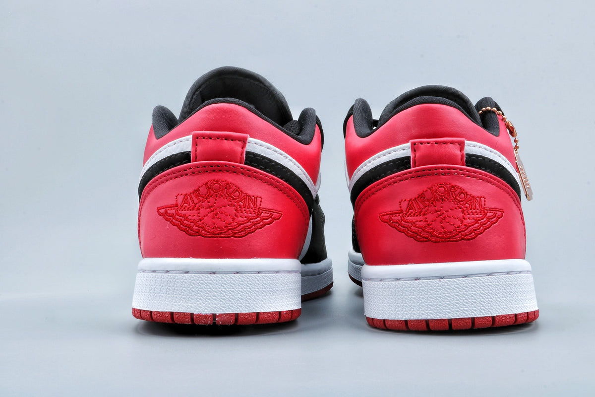 Jordan 1 Low Black Toe Sneakers in Black White Red - product image from the listing.