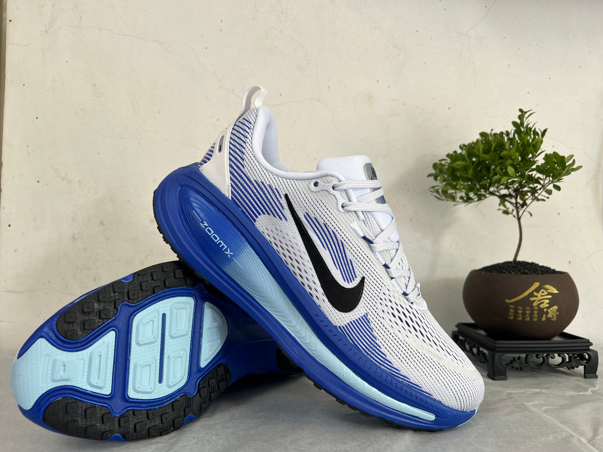 Nike Vomero 18 Running Shoes, in White and Blue - product image from the listing.