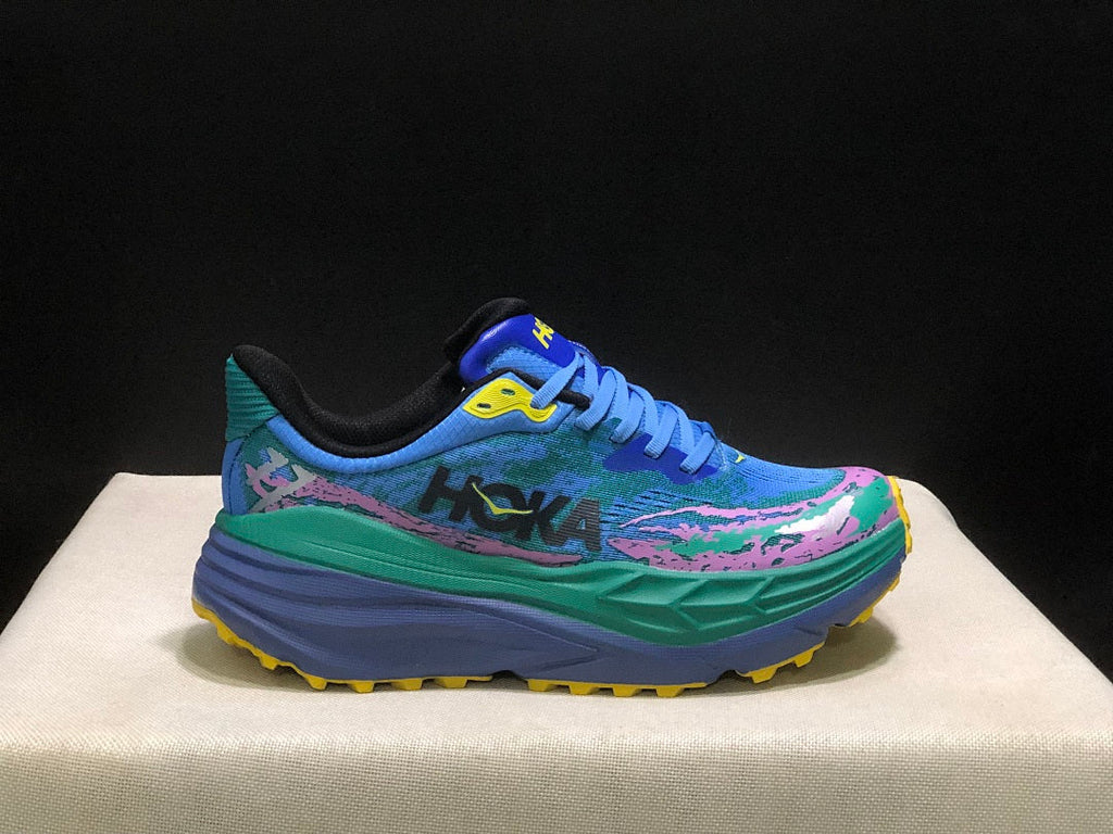 HOKA Stinson 7 Trail Sneakers in Blue Green Pink Yellow - product image from the listing.