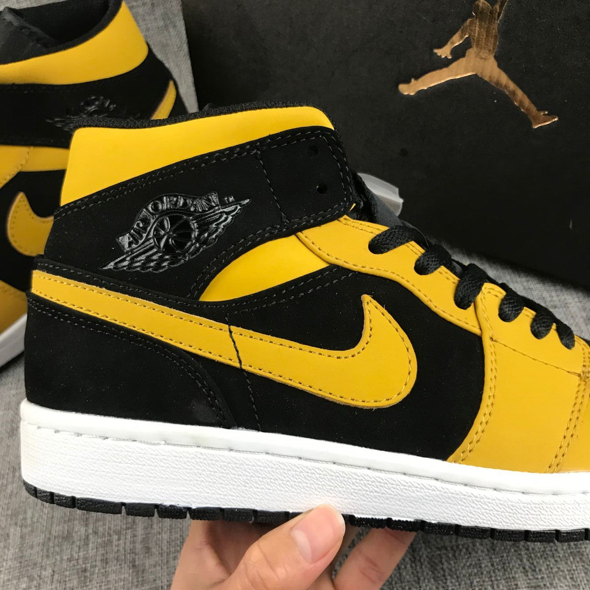Air Jordan 1 Mid Sneakers in Black and Yellow - product image from the listing.