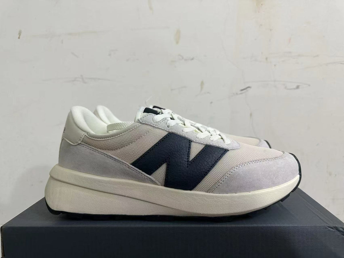 Gray and Navy New Balance U370 Sneakers - product image from the listing.